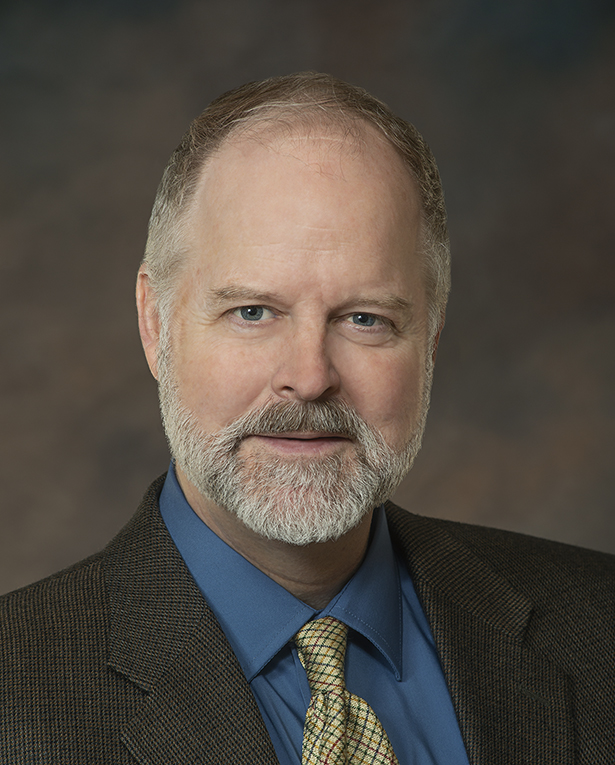 A profile headshot of Phil Robinson