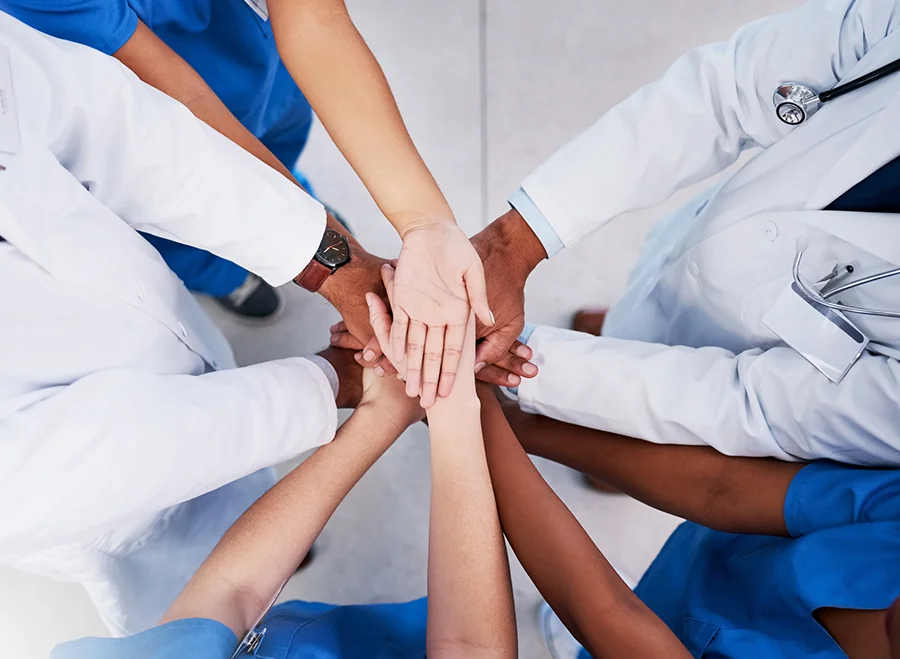 Doctors and nurses hands in middle